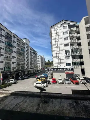 a parking lot with cars parked in a parking lot at Adik aisyah Cameron Black Pink in Tanah Rata