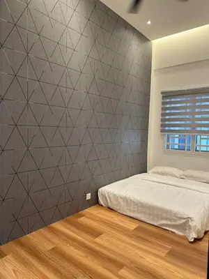 a bedroom with a bed and a wall at Adik aisyah Cameron Black Pink in Tanah Rata