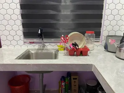 a kitchen counter with a sink with utensils at Sekinchan Homestay Teratak AZ - muslm only in Kampong Batu Dua Puloh Tiga