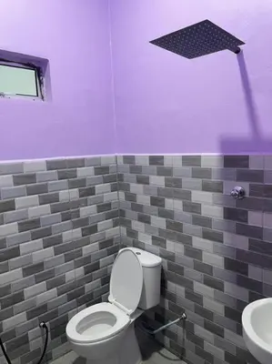 a purple bathroom with a toilet and a sink at Sekinchan Homestay Teratak AZ - muslm only in Kampong Batu Dua Puloh Tiga
