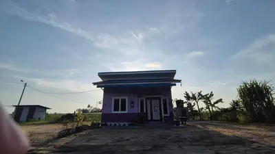 a small small house with a purple at Sekinchan Homestay Teratak AZ - muslm only in Kampong Batu Dua Puloh Tiga