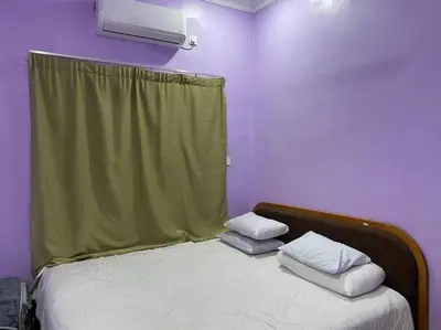 a bedroom with a bed with two pillows on it at Sekinchan Homestay Teratak AZ - muslm only in Kampong Batu Dua Puloh Tiga