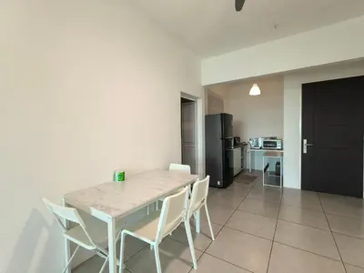 a white table and chairs in a room with a kitchen at Meritus Comfy 3 Bedroom with 8 Pax in Jalan Baharu