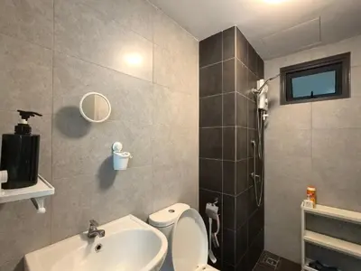 a bathroom with a toilet and a sink and a shower at Meritus Comfy 3 Bedroom with 8 Pax in Jalan Baharu