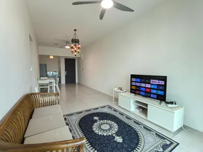 a living room with a couch and a flat screen tv at Meritus Comfy 3 Bedroom with 8 Pax in Jalan Baharu