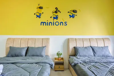 two beds sitting next to each other in a bedroom at Minion Escap Family Homestay in Brinchang Cameron Highland Clover Home 9-25 in Brinchang