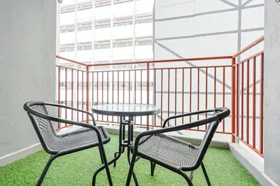 a table and two chairs on a balcony at Cozy Premium Family Homestay in Cameron Highlands Brinchang Clover Home 4-06 in Brinchang