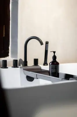 a bathroom sink with a bottle of soap on it at Heritage Villa by Aayu - 10 mins walk to Armenian St in George Town
