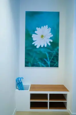 a picture of a white flower on a wall at Tung's Hideout- Centrum Cameron in Brinchang