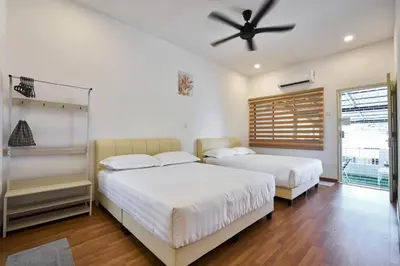 a bedroom with two beds and a ceiling fan at Ipoh South Homestay 8-16pax 10mins to attraction in Ipoh