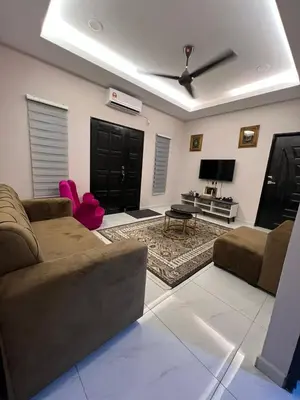 a living room with a couch and a ceiling fan at D'Nuha homestay Unit 2 Chenderong Balai Teluk Intan in Kampung Degong