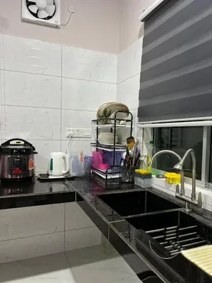 a kitchen with a sink and a counter top at D'Nuha homestay Unit 2 Chenderong Balai Teluk Intan in Kampung Degong