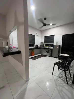 a large white kitchen with a table and a ceiling at D'Nuha homestay Unit 2 Chenderong Balai Teluk Intan in Kampung Degong