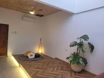 a room with a potted plant on the floor at Metime Ipoh Garden in Ipoh