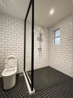 a bathroom with a toilet and a shower at The Petrichor in Tupai