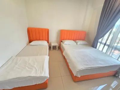 two beds in a small room with a window at Majestic The Imperial Tower - Ipoh in Ipoh