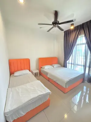 two beds in a room with a ceiling fan at Majestic The Imperial Tower - Ipoh in Ipoh