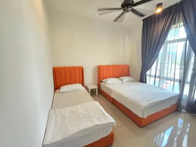 two beds in a room with a window at Majestic The Imperial Tower - Ipoh in Ipoh
