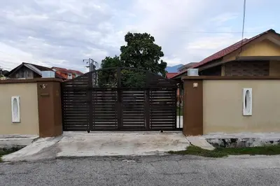 a black gate in front of a house at Ipoh Buntong Corner homestay in Ipoh