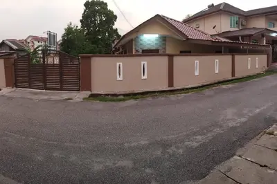 a house with a fence on the side of the road at Ipoh Buntong Corner homestay in Ipoh