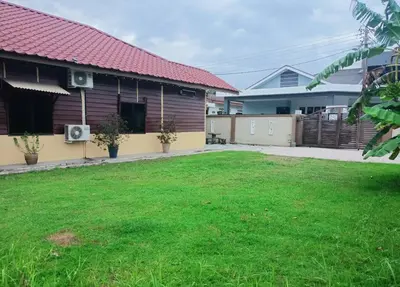 a house with a lawn in front of it at Ipoh Buntong Corner homestay in Ipoh