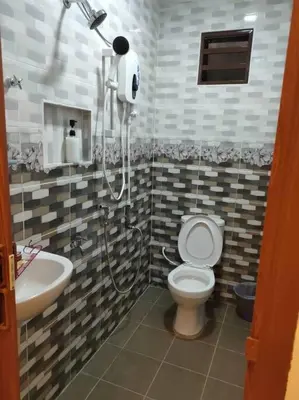 a bathroom with a toilet and a sink at Ipoh Buntong Corner homestay in Ipoh