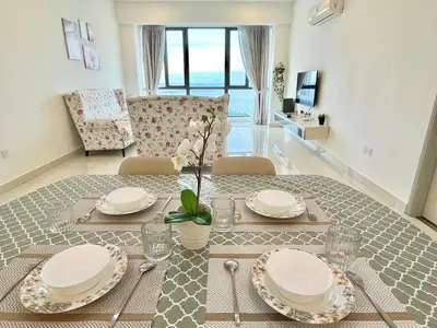 a dining room with a table with plates on it at Jazz Service Suite in Bagan Jermal