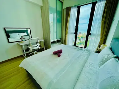 a bedroom with a bed with a pink object on it at Jazz Service Suite in Bagan Jermal
