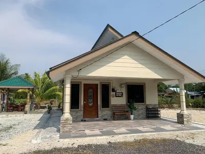 a small house with a porch and a door at Teratak Annur Homestay in Tanjung Karang