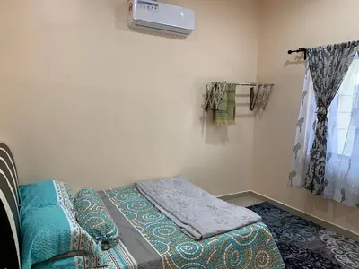 a room with a bed and a window at Teratak Annur Homestay in Tanjung Karang
