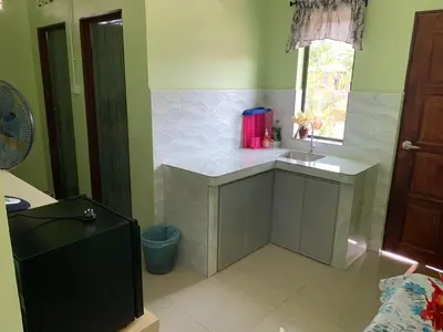 a small kitchen with a sink and a window at Teratak Annur Homestay in Tanjung Karang