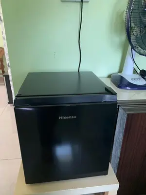 a black microwave sitting on top of a desk at Teratak Annur Homestay in Tanjung Karang