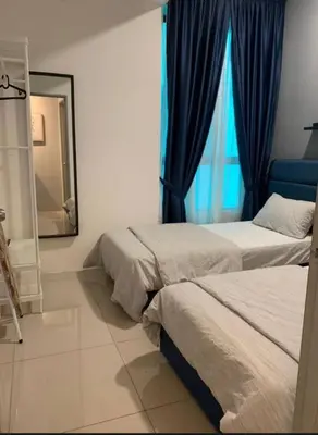 a bedroom with two beds and a mirror and a window at O Homestay Meru Ipoh at Casa Kayangan - Musleem in Bandar Meru Raya
