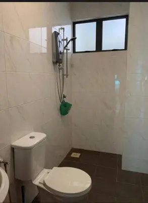 a bathroom with a toilet and a phone on the wall at O Homestay Meru Ipoh at Casa Kayangan - Musleem in Bandar Meru Raya