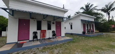 a building with red and purple doors on it at Chalet Meroloh Kuala Kangsar in Kuala Kangsar