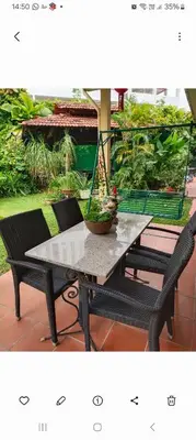 a table with two chairs and a potted plant on it at Will Ma in Ayer Itam