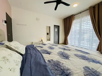 a bedroom with a bed and a ceiling fan at Khasif Amani Homestay Parit Buntar in Parit Buntar