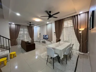 a living room with a table and chairs and a couch at Khasif Amani Homestay Parit Buntar in Parit Buntar