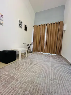 an empty room with a table and a curtain at Khasif Amani Homestay Parit Buntar in Parit Buntar