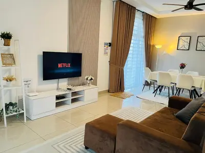 a living room with a couch and a television at Khasif Amani Homestay Parit Buntar in Parit Buntar