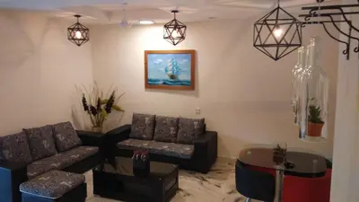 a living room with two couches and a table at Bercham Vacation House in Ipoh