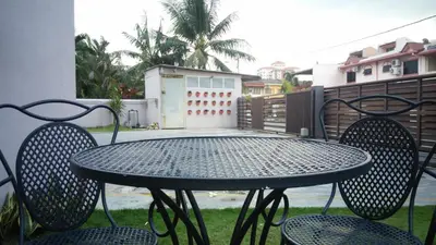 a table and chairs sitting on a patio at Bercham Vacation House in Ipoh