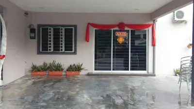 a front door of a house with a red curtain at Bercham Vacation House in Ipoh