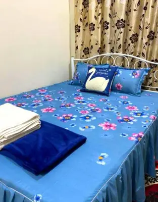 a blue bed with a swan pillow on it at CozyStayz Perak in Sitiawan