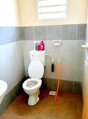 a bathroom with a toilet and a sink at CozyStayz Perak in Sitiawan