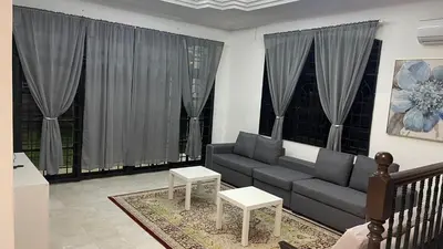 a living room with a couch and some windows at Homestay Rumah 25 in Sungai Petani