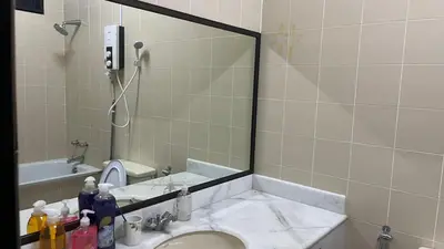 a bathroom with a mirror and a sink at Homestay Rumah 25 in Sungai Petani