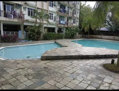 a swimming pool in front of a building at Bayu Emas Batu Ferringhi 2 in Ayer Itam