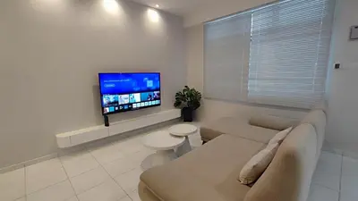 a living room with a couch and a flat screen tv at Minimalist Heaven Near Tmn Intan in Sungai Petani