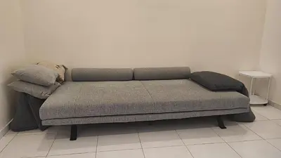 a couch with two pillows on it in a room at Minimalist Heaven Near Tmn Intan in Sungai Petani